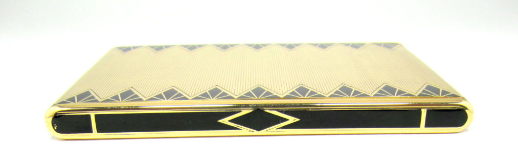 Fine & rare solid 18K gold cigarette case by Van Cleef & Arpels, circa 1920s. This unusual case features a ribbed surface with black enamel triangular designs customary of the art deco period. This case is also more distinguished in its single