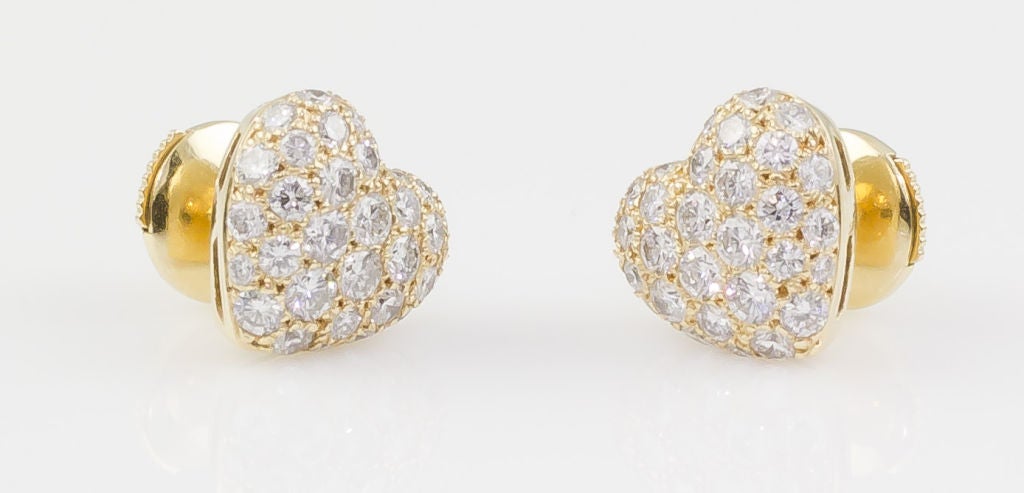 Timeless 18K yellow gold and diamond heart shaped earrings by Cartier. They feature approx. 1.75-2.0cts of high quality round cut diamonds. 

Hallmarks: Cartier, 750, reference numbers, maker's mark.