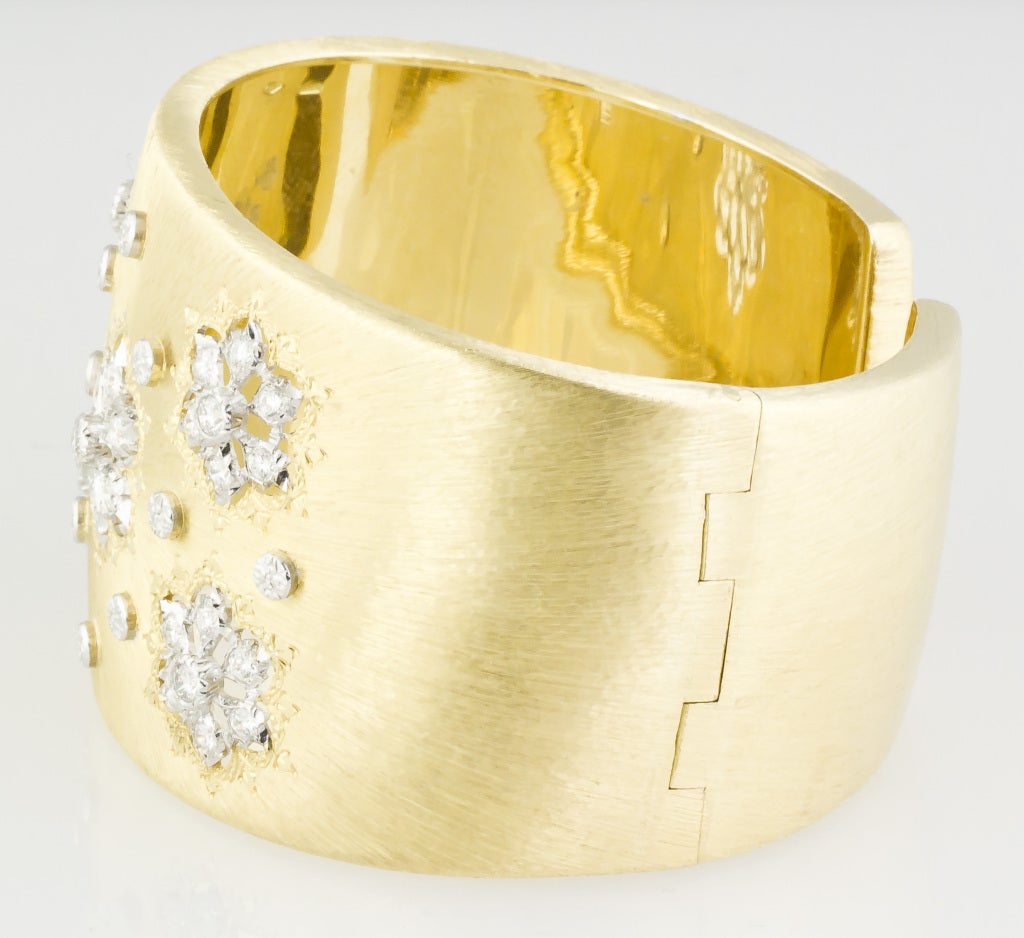Chic and bold 18k yellow gold and diamond wide cuff bracelet, by Mario Buccellati. This wonderful bracelet features two of the trademark Buccelati techniques: the satin-like gold 