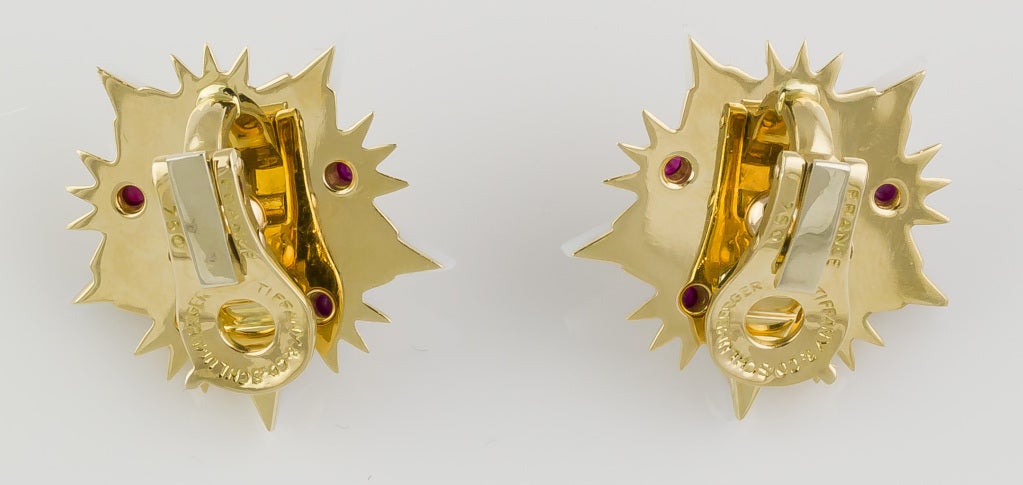 Chic and impressive 18k yellow gold, ruby and white agate earrings, by Tiffany & Co. Schlumberger.  They resemble a star, with white agate body and 18K gold framing, studded with cabochon rubies. Has long been discontinued and was only available for