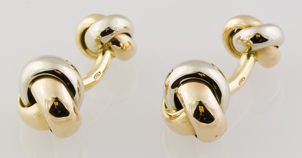 Classic and elegant 18K white, yellow and pink gold cufflink stud set from the "Trinity" collection by Cartier. They resemble knots, with one side slightly larger than the other on the cufflinks. Includes three studs.
Hallmarks: Cartier,