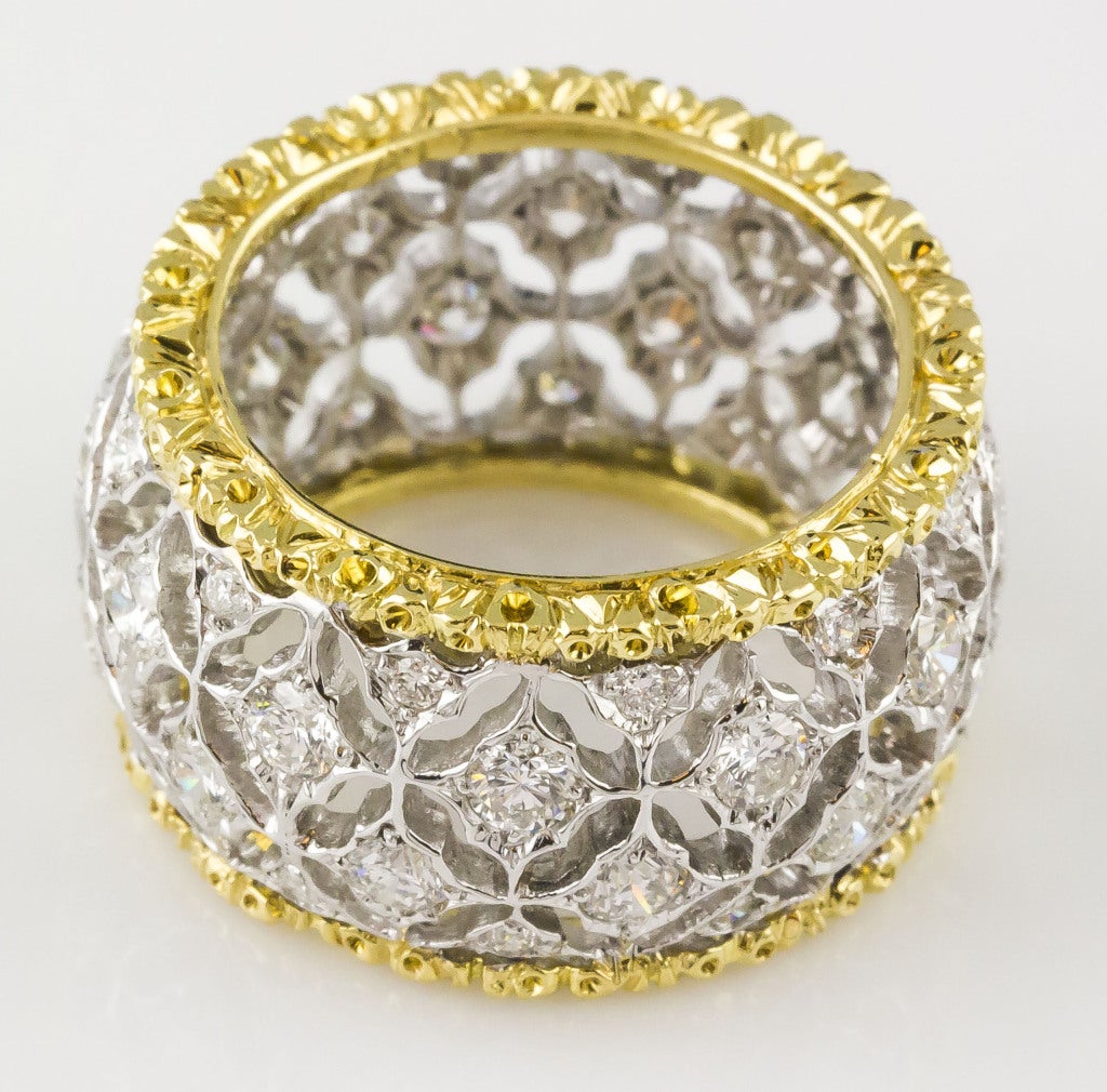 Intricate 18K yellow gold and 4 row diamond band ring by Mario Buccellati. It features high grade round brilliant cut diamonds of approx. 1.5cts, with two yellow gold rings around them. Size 6.
Hallmarks: M. Buccellati, Italy.