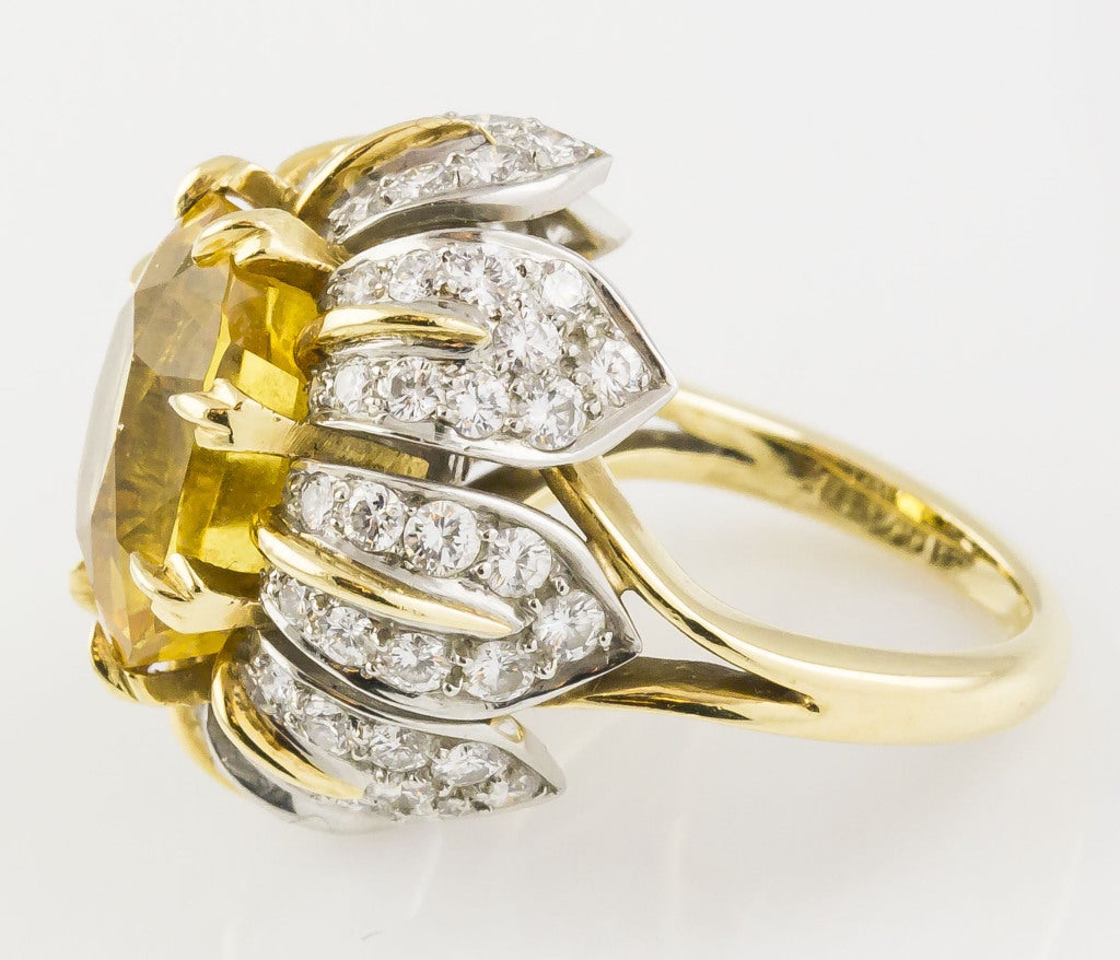 Bold 18K yellow gold and platinum cocktail ring by Tiffany & Co. Schlumberger. It features a very high grade yellow sapphire, also known as a 