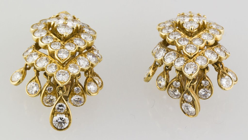 Chic 18K yellow gold and diamond dangle earrings by Van Cleef & Arpels, circa 1960s-70s. They feature approx. 7.0cts of very high grade round brilliant cut diamonds.
Hallmarks: VCA, Made in France, Copyright, reference numbers, maker's mark, French