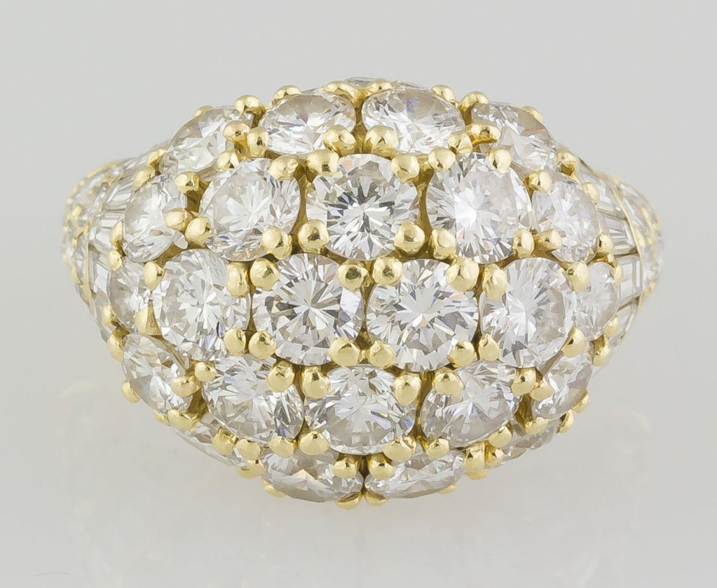 Contemporary and fashionable 18K yellow gold and diamond dome ring by Cartier. It features approx. 7.0-8.0cts of very high quality round brilliant cut and tapered baguette diamonds. Comes with Cartier certificate of authenticity (pictured). Size 7