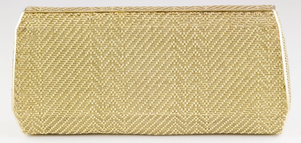 Elegant sapphire, diamond, 18K white and yellow gold basket woven clutch purse by Cartier, circa 1970-1980s. It features high grade square cut diamonds and sapphires on a bar clasp closure, which opens up to reveal a mirror. Of substantial weight,