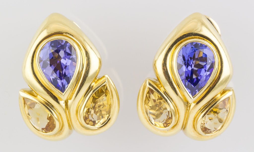 Rare and unusual 18K gold, tanzanite and citrine ear clips by Rene Boivin. They feature pear shaped citrines and tanzanites, for a bold and interesting look typical of this maker and perhaps an old Belperron design from her time with
