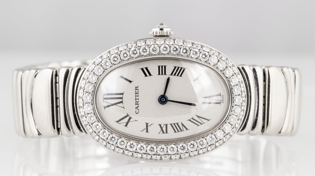 Elegant and feminine 18k white gold and diamond wristwatch from the Baignoire collection by Cartier. Two rows of high grade brilliant round cut diamonds. Quartz movement. Fully signed on case, dial and movement, as well as original Cartier bracelet