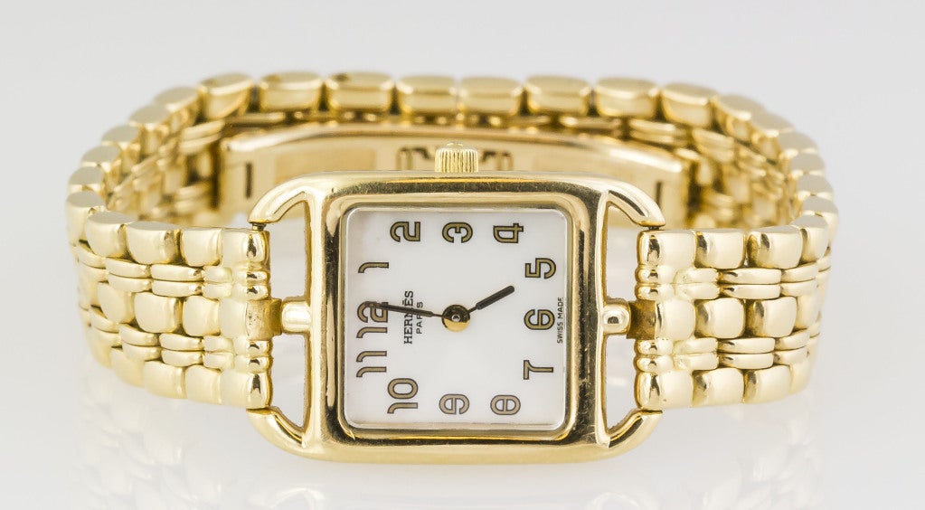 Chic 18K yellow gold quartz wristwatch from the Cape Cod collection by Hermes. Features an 18K gold link bracelet with deployment clasp. Retailed for $20,000.

Hallmarks:  Hermes Paris, reference numbers, maker's mark,  .750.