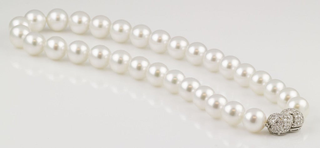 Exceptionally fine and rare Harry Winston pearl necklace with diamond set platinum clasp. It features pearls of 13-14mm diameter, AAA quality, slightly pinkish/silver white hue of exceptional luster and nacre, relatively blemish free; truly pearls