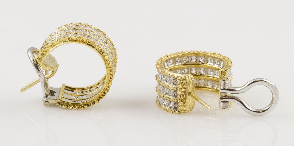 Expertly crafted diamond and 18K yellow & white gold huggie earrings by Mario Buccellati. They feature three rows of high quality round brilliant cut diamonds of approx. 2.00-2.25 carats total weight, all set in white gold with yellow gold