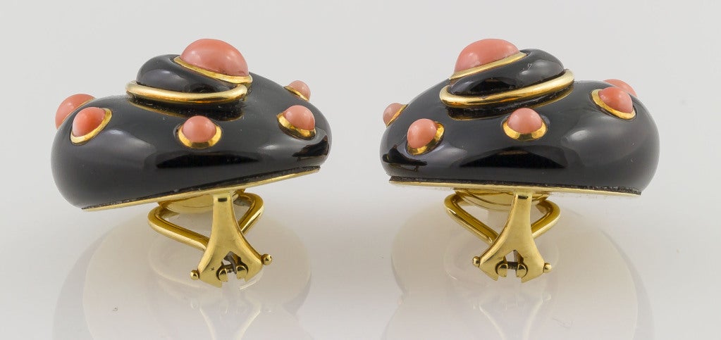 Chic 18K yellow gold, black onyx and coral earrings by Verdura. These earrings are no longer available, and this particular combination of onyx and coral is ones of the most desirable made.  The shape resembles a seashell with an onyx body and 18k