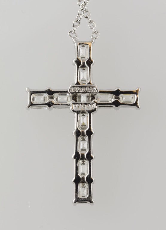 Classic platinum and diamond cross pendant necklace by Tiffany & Co. This wonderful necklace was made to order by Tiffany & Co. and is not readily available in stores.  It features very high grade emerald cut diamonds, approx. G color VS1-2 clarity,