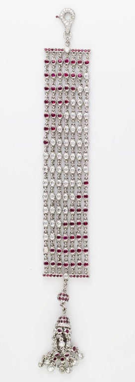 Bold and impressive platinum, diamond and ruby bracelet by Graff. Designed as a mesh bracelet, it also features a beautifully jewelled tassle and a diamond encrusted 