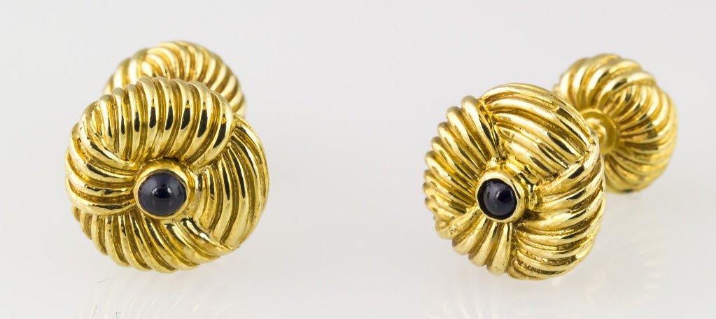 Elegant and masculine cufflink stud set by Tiffany & Co., Schlumberger, circa 1970s. Features rich blue cabochon sapphires on each end, as well as four studs. 
Hallmarks: Tiffany, Schlumberger, 18k.