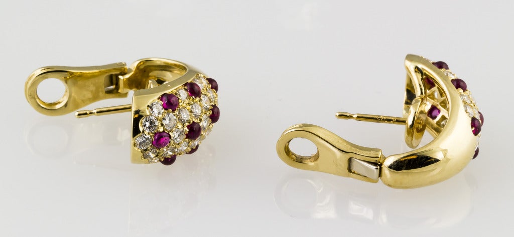 Classic 18K yellow gold, diamond and ruby earrings by Cartier. These are referred to as 