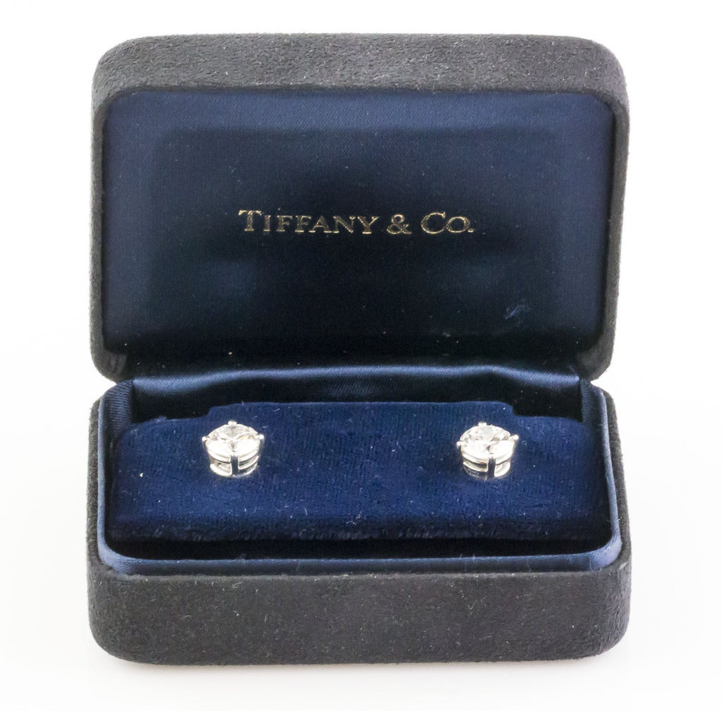Timeless platinum & diamond stud earrings by Tiffany & Co. They feature tow round brilliant cut diamonds: one is 1.65 carats I color VVS1 clarity , while the other is 1.62 carats I color VVS2 clarity. They come with GIA certficates and Tiffany