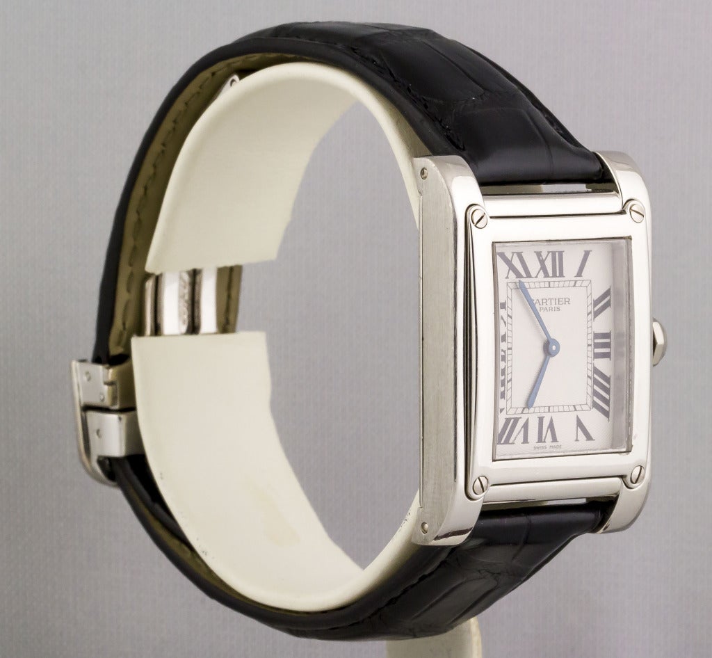 Cartier platinum Tank a Vis Privee collection wristwatch. Features a mechanical movement, Roman numeral dial, original Cartier leather strap and 18K white gold Cartier deployment buckle.

Signed Cartier on dial, Cartier on case back, No. 0063MG,