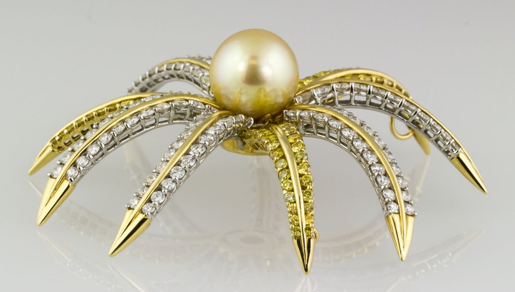 Bold and vibrant 18K yellow gold, yellow pearl, and diamond brooch by Tiffany & Co. It features approx. 9.0cts of very high grade white round brilliant cut diamonds, and  approx. 4.5cts of fancy colored canary yellow diamonds. The center pearl is
