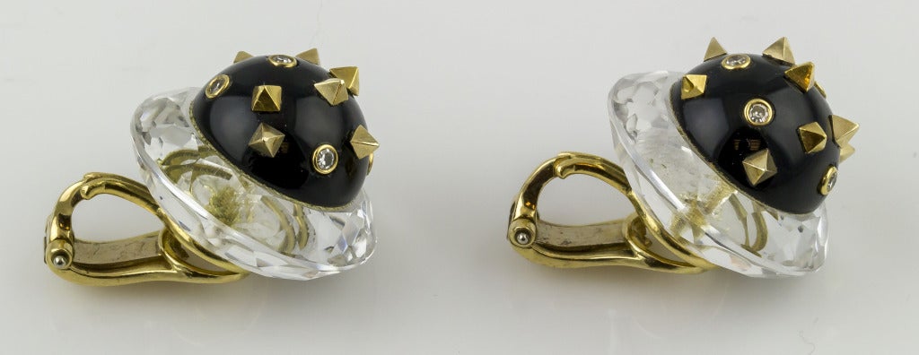 Highly unusual 18K yellow gold, diamond, rock crystal and earrings from Angela Kramer. They feature black enamel half spheres studded with tiny 18K gold pyramids and adorned with high grade round brilliant cut diamonds; with a rock crystal ring