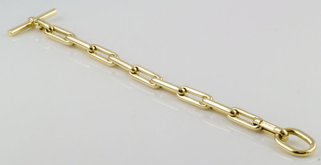 Classic Hermes 18k gold toggle bracelet.  Hallmarks: Hermes, Au750, reference numbers.