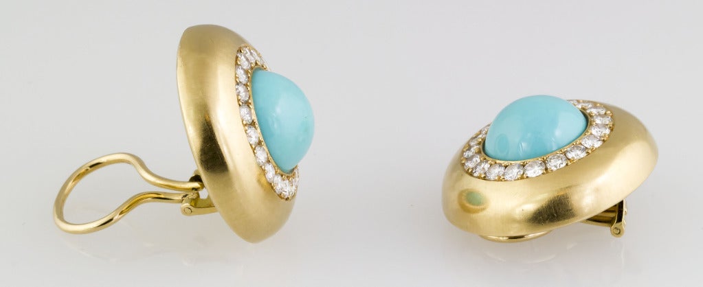 Classic and elegant earclips by Hemmerle.  They feature rich baby blue turquoise stones at the center, approx. 12mm in diameter, encircled by approx. 2.5-3.0 carats of very high quality round brilliant cut diamonds. Hallmarks: Hemmerle, 750, GH.