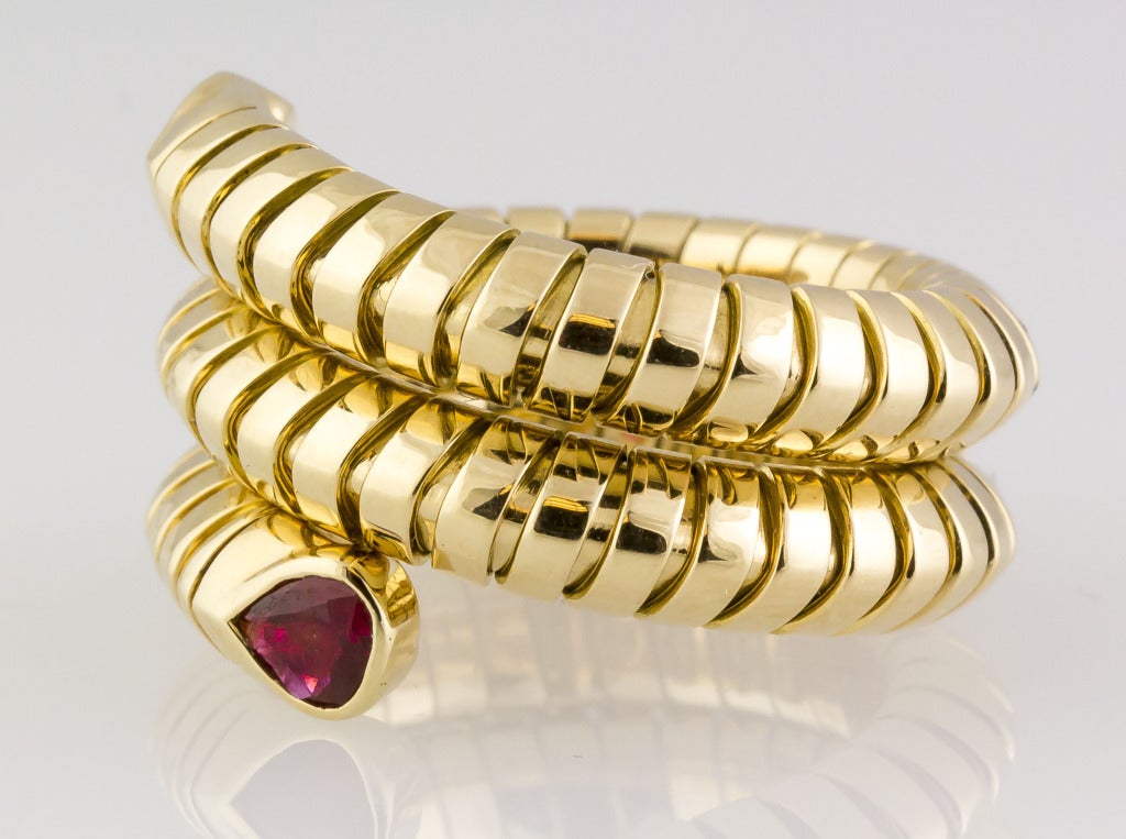 Elegant snake-like coil ring, in the "tubogas" style, by Marina B., featuring two pear shaped rubies at its ends. Rubies are in rich red color and well saturated. Currently a size 8 but flexible.
Hallmarks: Marina B., 750, Made in Italy,
