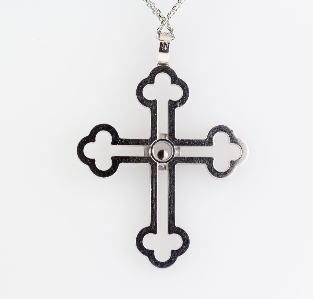 Ornate 18K white gold and diamond cross pendant from the 