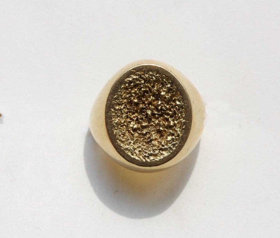 An 18 carat gold ring with a samorodok decoration, signed: John Donald, London, circa 1970.

weight: 13.2 grams.