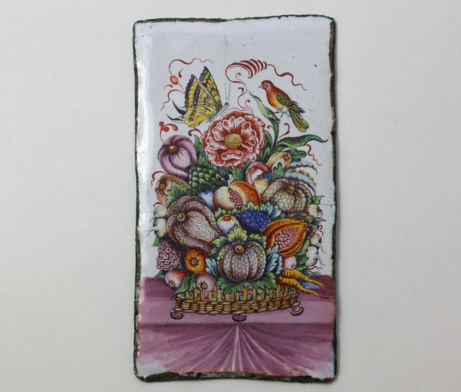A elegant 17th century, enamel plaque on copper, multicolored with lots of manganese, representing a basket with fruits, vegetables, a buttercup with a butterfly and a bird on it, Western Europe, 17th century.

dimensions: 9.5 x 5.3 cm.