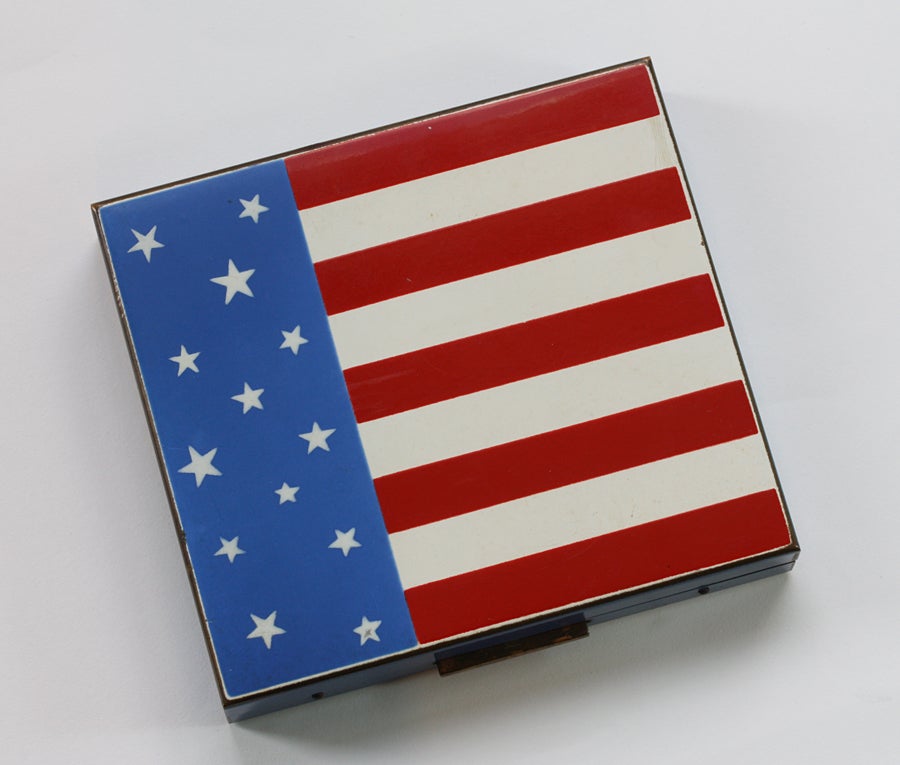 A metal cigarette box with the American stars & stripes in red, white and blue enamel, U.S.A., circa 1945.