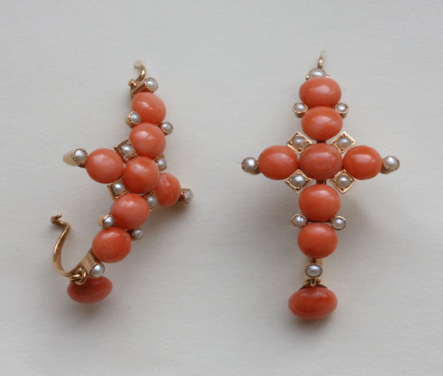 A pair of large 18 carat gold earrings with cabochon corals and small half natural pearls in the shape of crosses, France, 19th century.