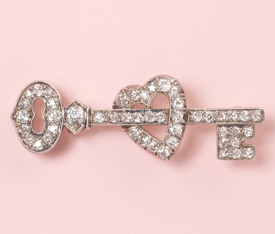 A silver key to my heart brooch with gold backing set with pretty brilliant cut diamonds (app. 2.25 carats), England, this brooch refers to the only person that the other truly loves, and only they know how to show their love (Heart), the diamonds