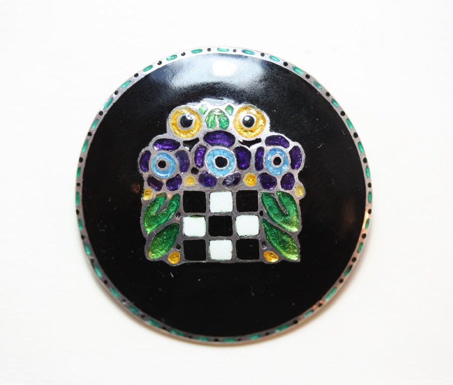 A rare and early round silver Farhner brooch with an abstract flower basket in colorful enamel on a black enamel background, signed: TF 935 for Theodor Fahrner, circa 1906, Pforzheim.

possibly designed by Herman Hausler for Fahrner.

compare: