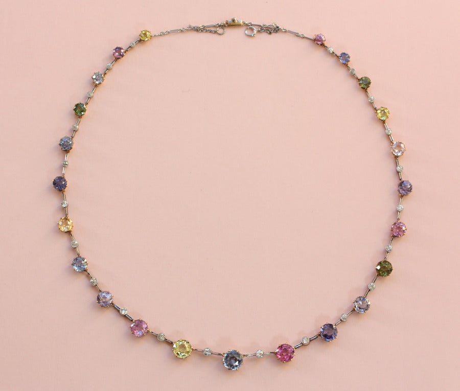 An 18 carat gold necklace with 23 brilliant cut sapphires all natural unenhanced and in different colors (circa 20 carats) alternated with brilliant cut diamonds (app. 1.5 carats) in a platinum mounting, England, circa 1910.

weight: 20 grams