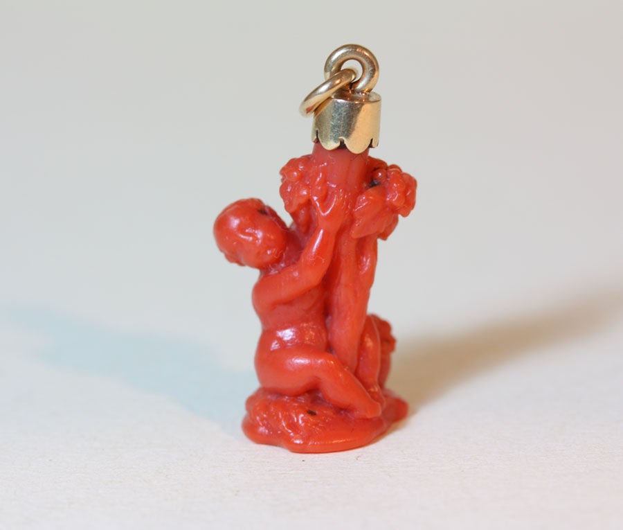 small coral sculpture of a putto