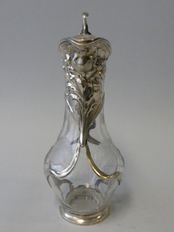This Russian Silver Mounted Cut Crystal Decanter is decorated in a sinuous  Art Nouveau inspired motif.  It was made circa 1920 and is hallmarked 800 designating the silver standard.  The crystal body of the decanter is beautifully carved in a