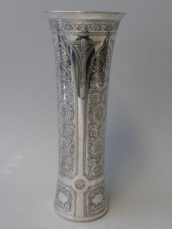 A stunning American cylinder shaped Sterling silver Flower Vase decorated in a deep acid etched design of baskets of flowers, topiaries and ornate scrolled flora and fauna motifs. Made by Tiffany & Co., New York. Fully hallmarked with Tiffany & Co.