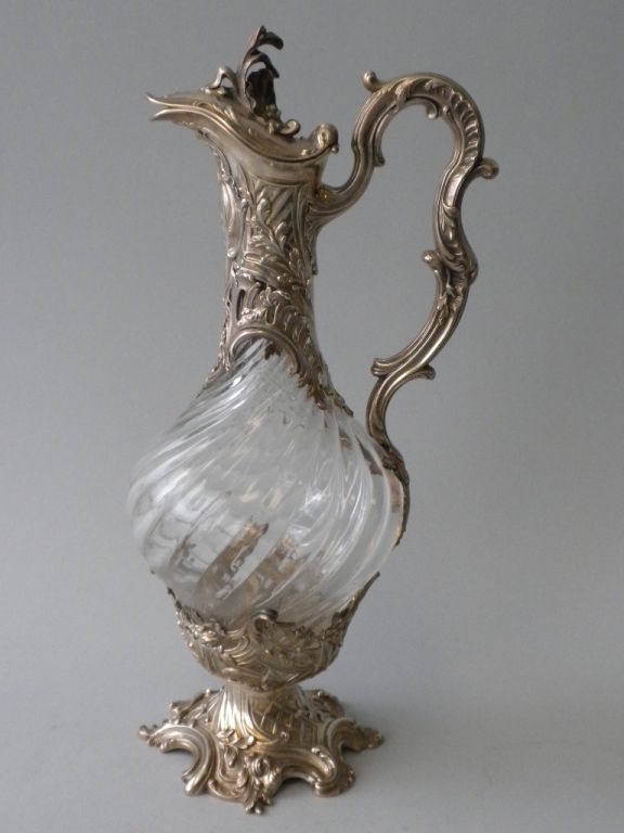 This elegant pair of French 1st Standard Silver (950/1000) Mounted Crystal Decanters was made by the Paris silversmithing firm of V. Boivin, Circa 1900.  The swirled crystal bodies are mounted with Louis XV style silver mounts with undulating scroll