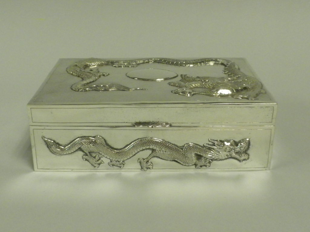 Striking Dragon Embossed Chinese Export Silver Table Box by Yoksang, Circa 1890.  This is one of the nicest Chinese silver table boxes we have had in a long time.  The box is hallmarked on the underside of the base with a Chinese character hallmark