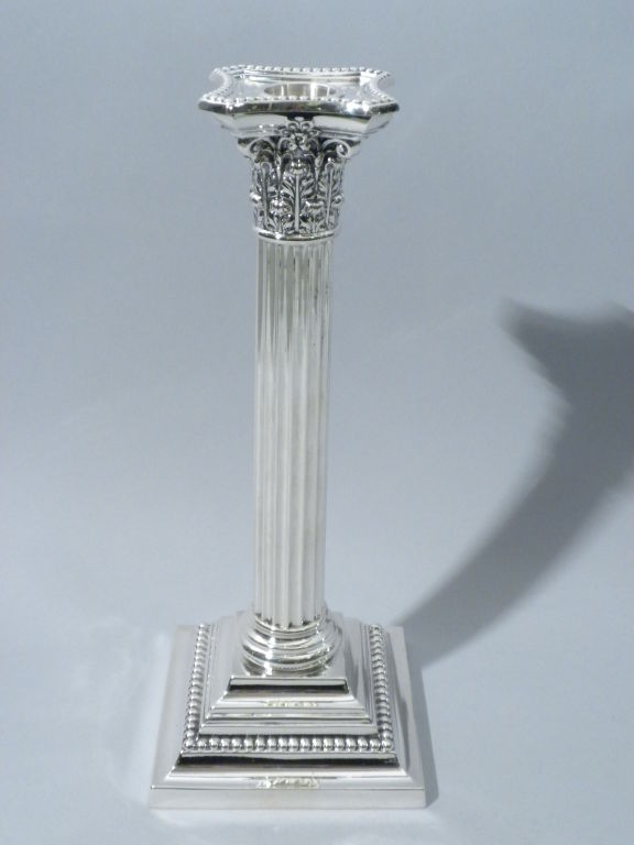 Pair of Gorham Mfg. Co. Sterling silver Candlesticks, Providence, RI, Circa 1940.  This pair of candlesticks was made in the form of fluted Corinthian Columns on a square stepped beaded plinth form base.  The candlesticks are marked under the base