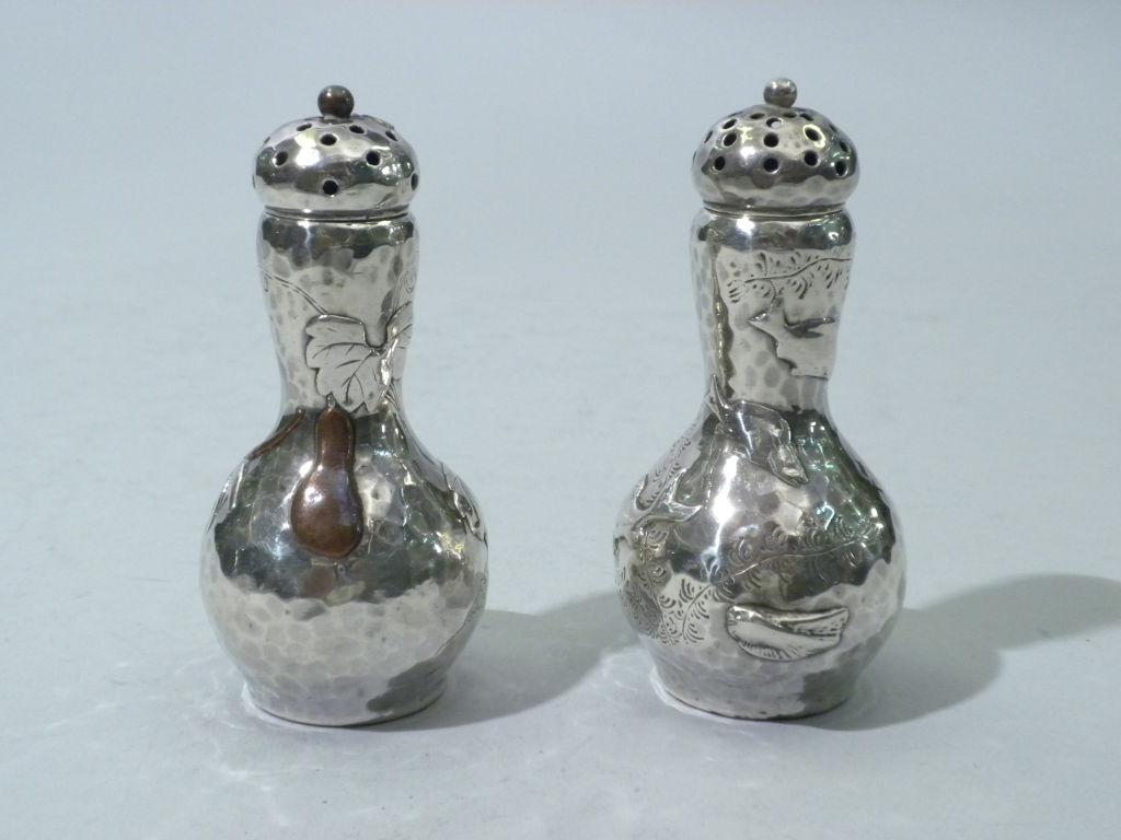 Fabulous Pair of Antique Tiffany & Co., New York, Sterling Silver and Mixed Metals Salt and Pepper Shakers, Circa 1878.  The shakers are designed in a gourd shape, one applied with sterling fish and engraved with seaweed, the other with mixed metal