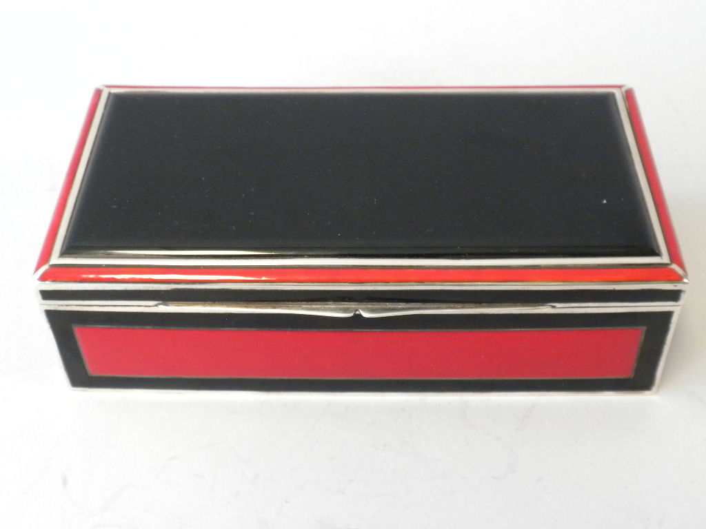 This is a wonderful box retailed by Tiffany & Co., Circa 1925. Enameled all over in Red & Black Enamel. Beautiful workmanship. The interior lined in wood. Marked along inside edge. Tiffany & Co Sterling 935 Germany. 935 silver is actually a higher
