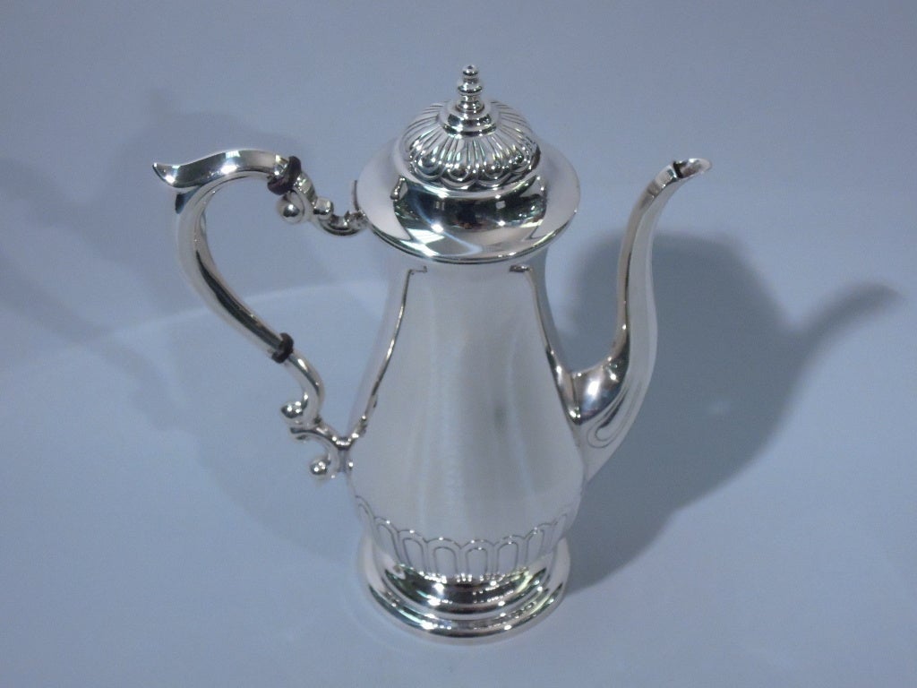 Sterling silver tea service. Made by Manchester Silver Co. in Providence, ca. 1910. The service comprises 1 coffeepot with hinge dome cover, 1 sugar bowl, and 1 creamer. Circular feet, scrolled handles, and repoussé gadrooning. A pretty service for