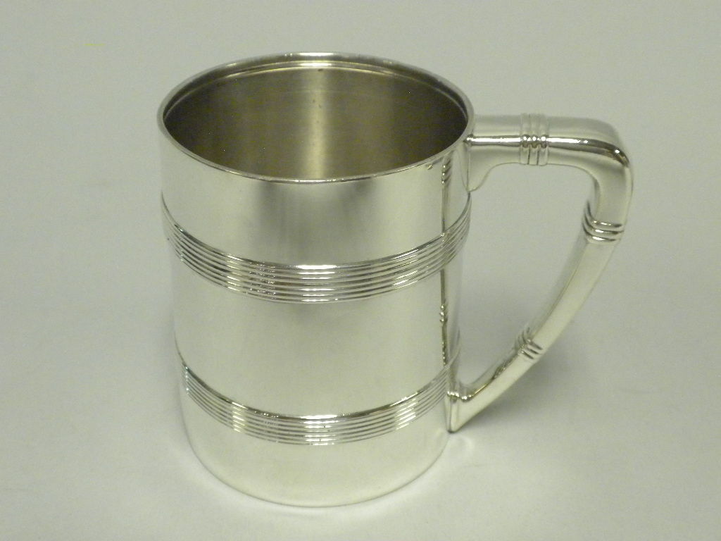 An Antique American Sterling Silver Baby Cup decorated with a classic design of applied ribbed bands. Made by Tiffany & Co., New York, N.Y. Circa 1895. Fully Hallmarked including the “T” date stamp. Perfect Condition. Excellent Patina. 5.5 Troy