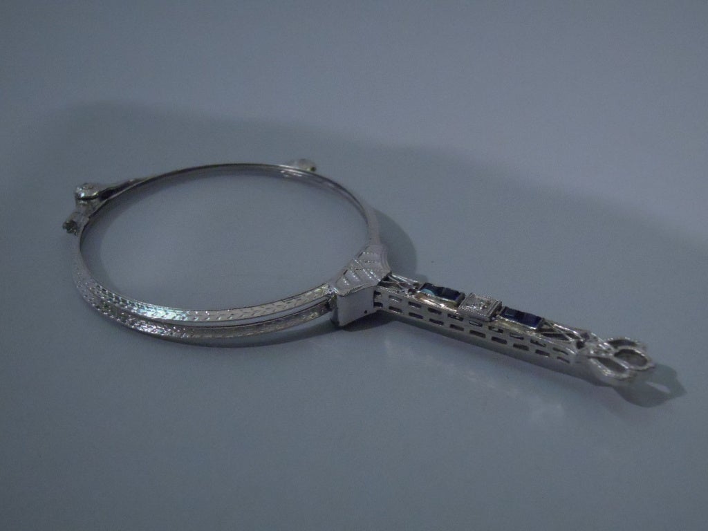 American 14 kt white gold lorgnette inset with diamonds and sapphires. Get in touch with your inner dowager. To be deployed at the next business meeting. 
Dimensions: Height: 3 ½ in. Width: 1 ¾ in. 

In silk-lined case. #1018