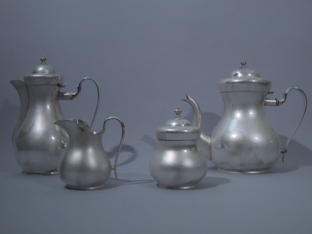 Sterling silver tea and coffee service. Made by Buccellati in Italy. This service comprises 1 coffeepot with hinged cover, 1 teapot with hinged cover, 1 creamer, and 1 sugar with cover.
Each: baluster body with flared foot ring. All handles are