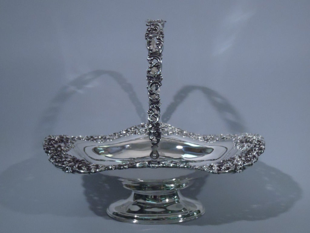 Sterling silver basket made by Black, Starr & Frost in New York c1890. Solid and ovoid bowl has curved sides. Rim is pierced, with scrolls and flowers as its swing handle. Rests on ovoid foot. Hallmarked. Excellent condition, with good patina.