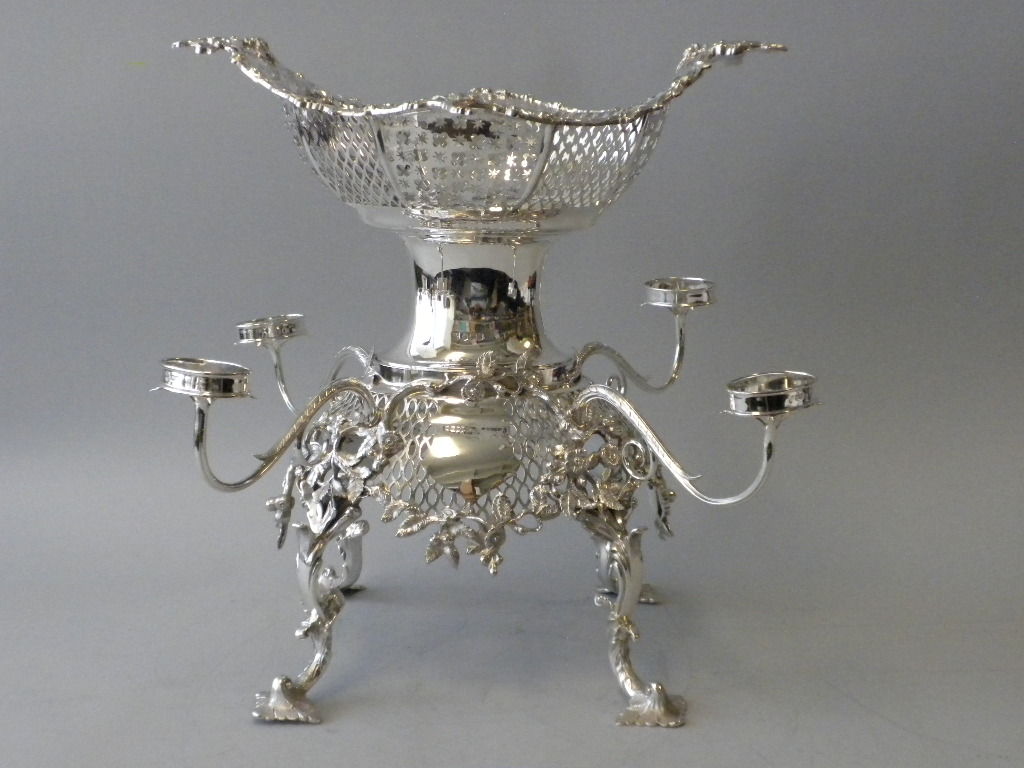 This magnificent Georgian reproduction sterling silver five basket epergne, or centerpiece, was made by Thomas Bradbury and Sons of Sheffield, England in 1924, and was retailed by Shreve, Crump and Low, Co. of Boston, Mass.  The epergne is in the