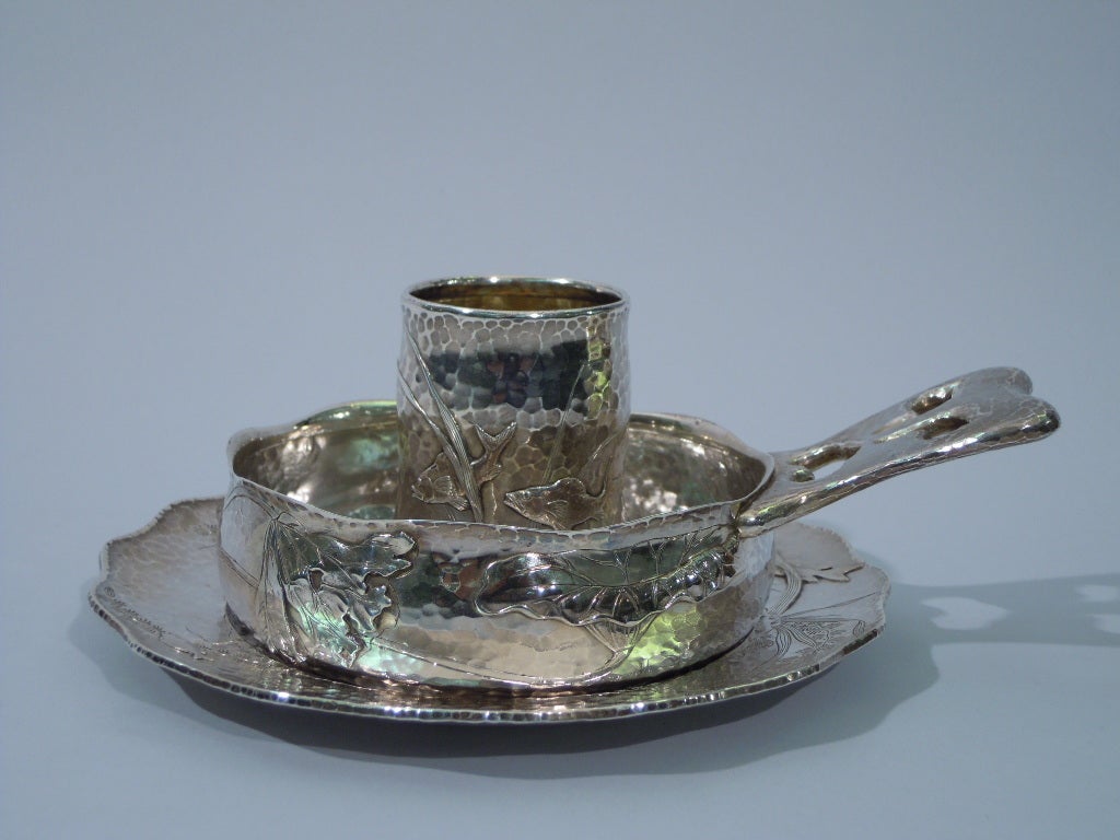 Japanese-style sterling silver youth set with marine ornament and honeycomb hand hammering. Made by Tiffany in New York c1879. 

This set comprises 1 baby cup (no. 5635), 1 porringer (no. 5515) and 1 plate (no. 5516). The cup is a beaker with